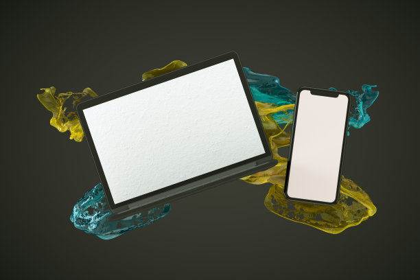 智能手机和笔记本电脑与液体油漆飞溅在黑色背景图片下载
