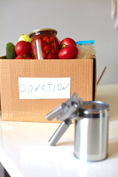 盒子里装着慈善捐赠的食物。罐头食品，意大利面，腌番茄，蔬菜，米饭。食品配送或食品捐赠理念。图片下载