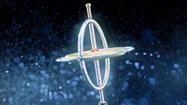 金属陀螺仪在五颜六色的闪光尘埃中旋转图片下载