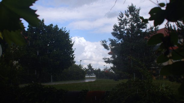 雨点滴落在四合院的草地上。天气潮湿，天空乌云密布。图片下载