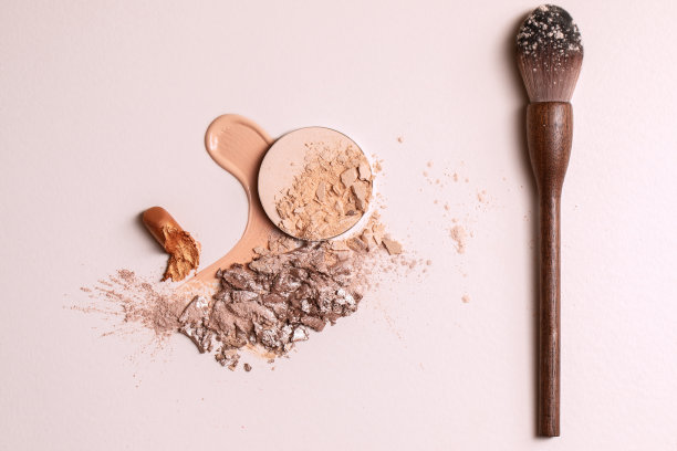 粉末状米色面漆和液体粉末状漆刷及零废木粉。米色背景上的彩妆宏观纹理图片下载