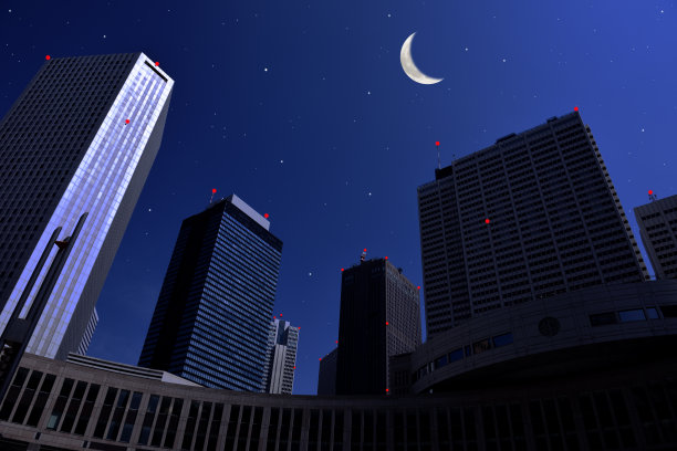 新月从摩天大楼上冉冉升起，上面布满了星星图片下载