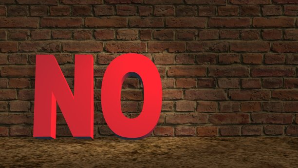 沙地上没有红字，靠在黑色的砖墙上图片下载