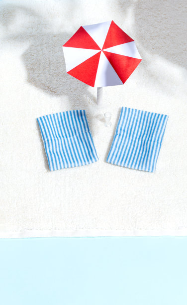 夏日沙滩，阳光躺椅，雨伞，大海，阴影。极简主义的概念。放松和宁静。俯视图图片下载