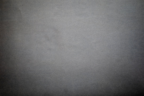 砂纸纹理背景在砂纸上形成美丽的黑色沙粒图案，适合作为插入文本的背景。复制空间供设计师在砂纸上使用。图片下载