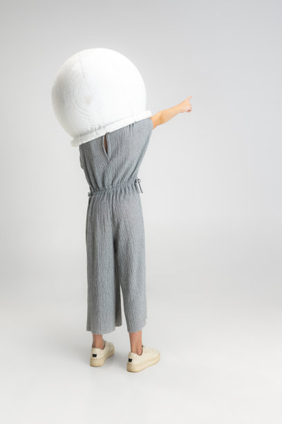 小学校白种人女孩的肖像在大头盔摆姿势孤立在白色工作室背景。图片下载