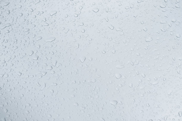 雨滴和露水。雨点落在灰色的车顶后停止下雨，选择性聚焦防水表面。软的焦点。留出书写文字背景的空间。图片下载