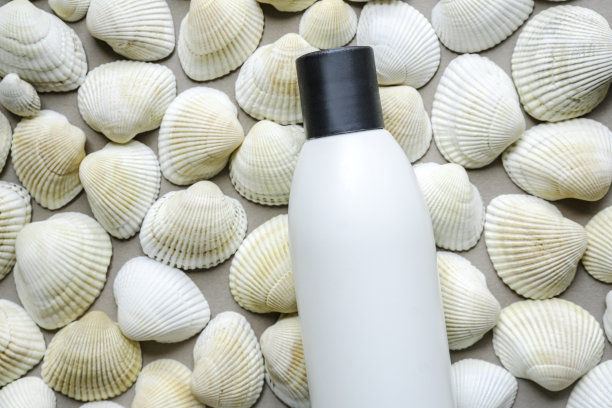 以海洋矿物质为基础的天然化妆品。概念由白瓶子和海贝壳。图片下载