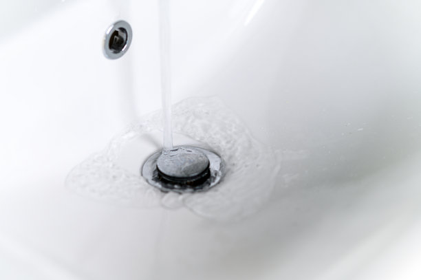 现代金属水龙头带自来水的厨房水槽图片下载