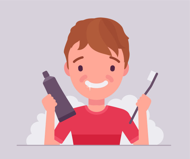 一个男孩用刷牙，拿着牙膏，牙刷来保持牙齿清洁图片下载