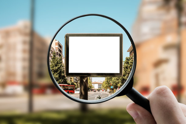 在城市中聚焦大空白广告牌的放大镜图片下载