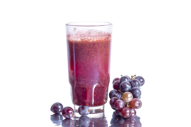 红色葡萄汁在玻璃和葡萄果实孤立在白色的背景图片下载