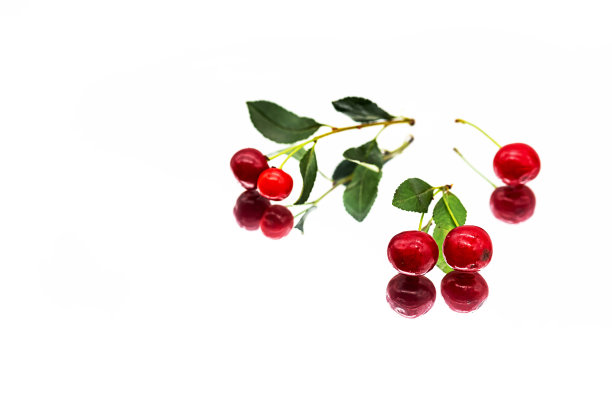 新鲜、成熟、绿叶的樱桃。有倒影的樱桃。图片下载