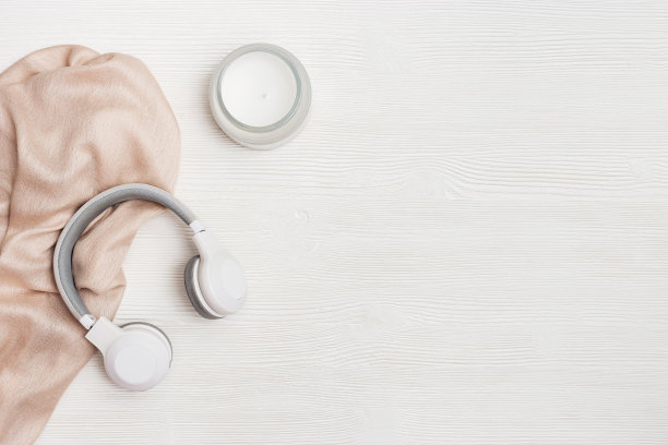 家庭放松概念耳机和香薰蜡烛在玻璃罐中木头。宁静的休息氛围图片下载