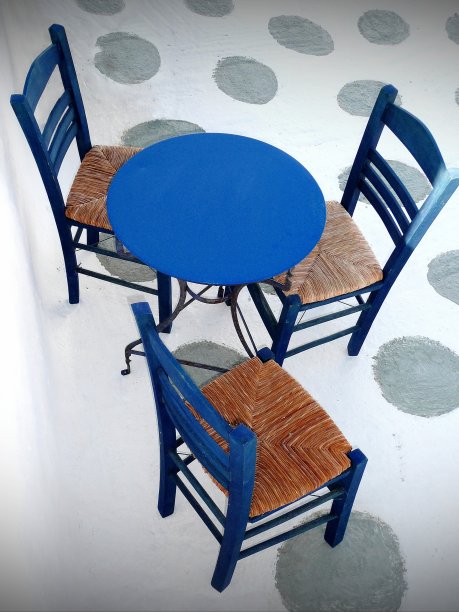 希腊米科诺斯岛，白色巷子里传统的蓝色咖啡桌和椅子图片下载