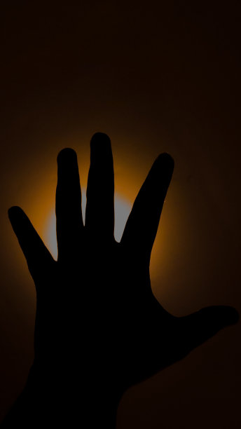 手在白橙色的灯光下图片下载