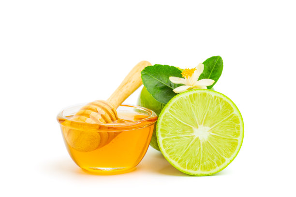 蜂蜜勺和蜂蜜碗和石灰与石灰花孤立在白色背景。健康的有机，天然食品，配料。养蜂的产品。图片下载