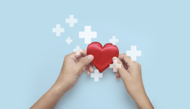 手牵红心。心脏健康捐赠概念图片下载