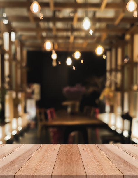 空木制桌面与灯光散景模糊餐厅背景图片下载