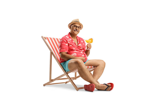 年长的男性游客坐在椅子上喝鸡尾酒图片下载