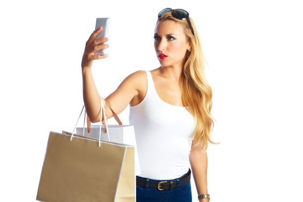 金发购物狂女人包和智能手机图片下载