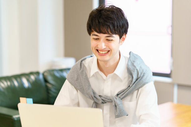 一个年轻人在休闲间里使用笔记本电脑图片下载