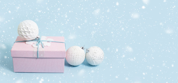 粉红色的圣诞礼品盒与白色的小玩意在蓝色图片下载
