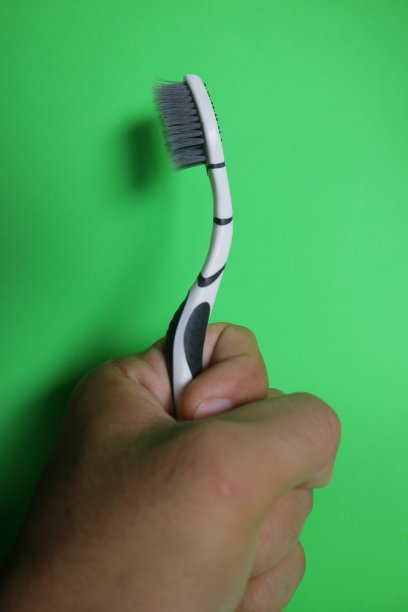 用牙刷在孤立的背景照片上清洁牙齿图片下载