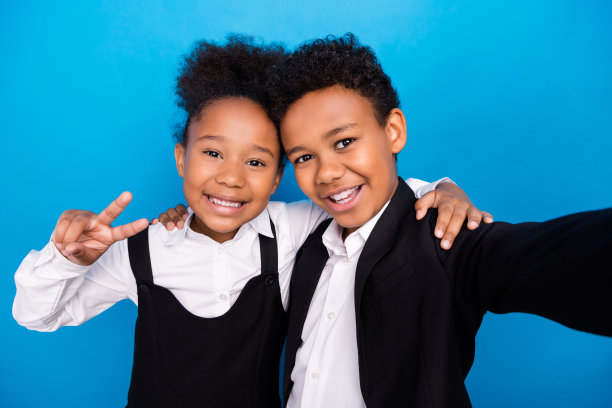 深色皮肤的照片，小孩子，人，朋友，使自拍穿正装制服v标志孤立在蓝色背景图片下载