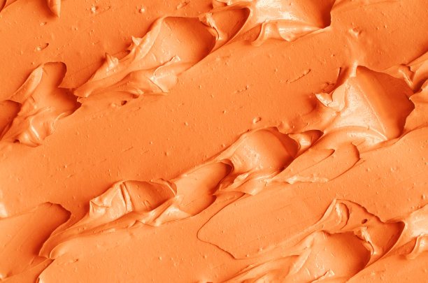 橙色南瓜面膜(面霜、姜黄身体磨砂、赤陶泥)纹理贴近，选择性聚焦。抽象的背景与笔触。图片下载