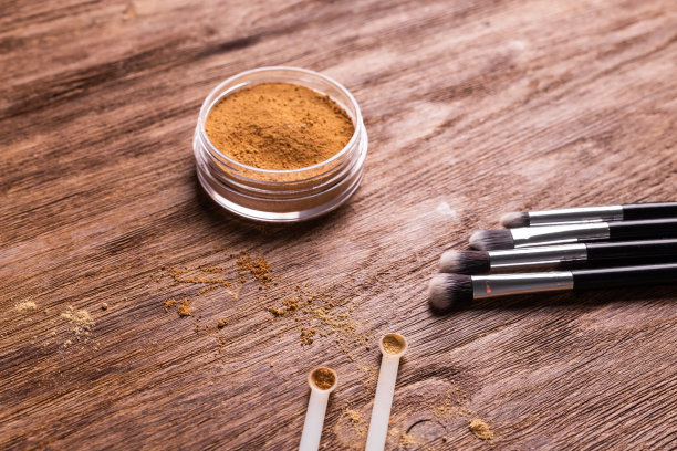 松散的粉状矿物粉末用于脸部和刷子用于木制背景上的粉末和面部。环保有机化妆品。图片下载