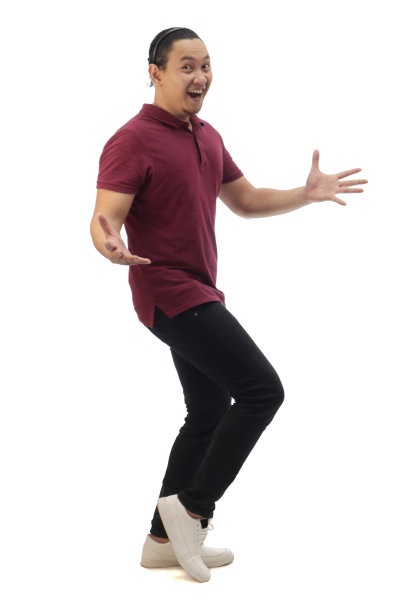 身穿红色休闲衬衫、黑色牛仔布和白色鞋子的男子，微笑着指着或展示他身边的东西。全身肖像隔离图片下载