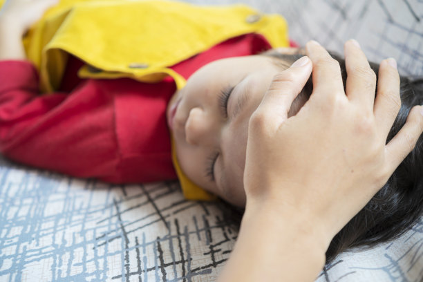 亚洲父母抚摸孩子头的照片。图片下载