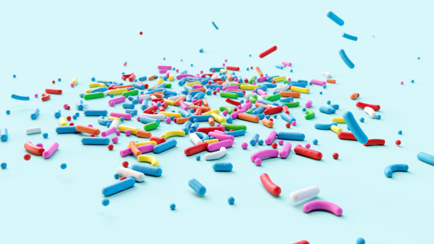 糖的小点落下来装饰蛋糕和面包圈，很多糖屑作为背景图片下载