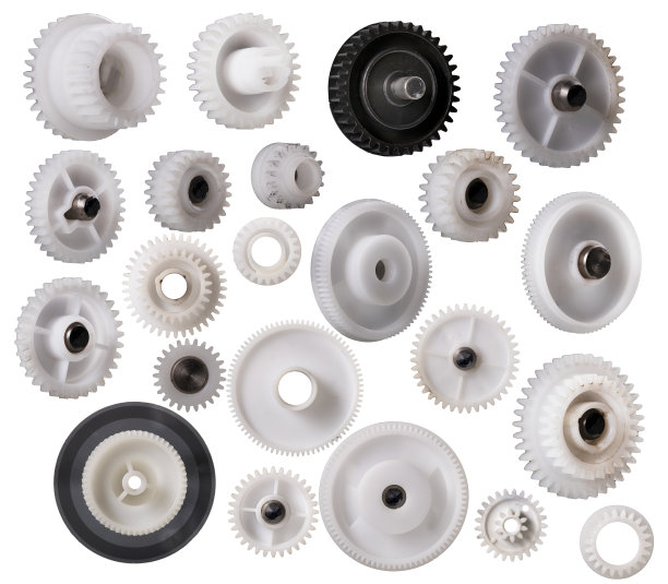 塑料齿轮扭矩传输。修理印刷设备的零配件。孤立的背景。图片下载
