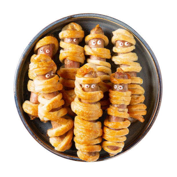 万圣节木乃伊热狗。灰色盘子上裹着生面团的香肠，眼睛被包裹在白色背景上。疯狂有趣的万圣节食物。图片下载