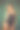 穿黑色泳衣的女孩。绿色背景下的年轻女子肖像图片下载