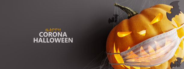 笑雕南瓜，带着医用防护面具和飞行蝙蝠。万圣节的概念背景图片下载