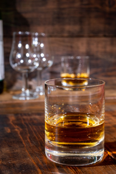 在古老的酒吧里，深色木桌上摆着几杯浓烈的苏格兰纯麦芽威士忌图片下载