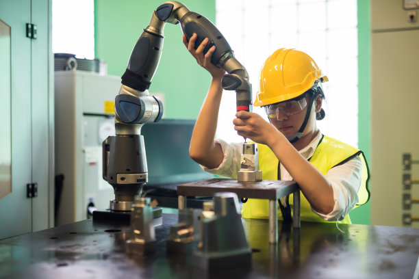 工厂工程师检查铣削机器人手臂图片下载