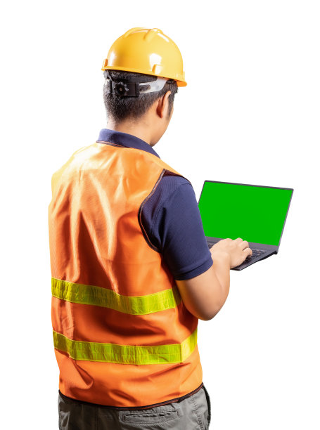 亚洲的工程师或技术员戴着头盔和背心，拿着电脑笔记本图片下载