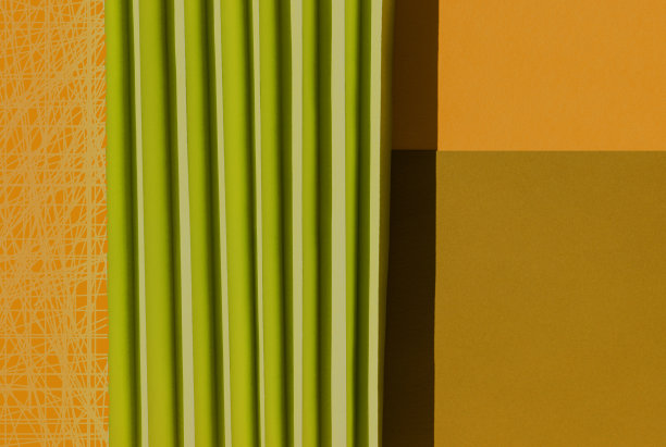 抽象橘色和绿色的纸张质感。折叠的纸有强烈的阳光阴影，几何形状和线条。极简主义的背景。图片下载