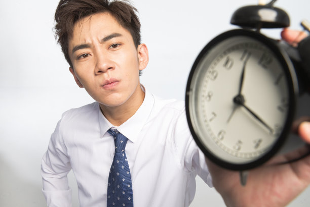 商务青年男人拿着闹钟图片下载