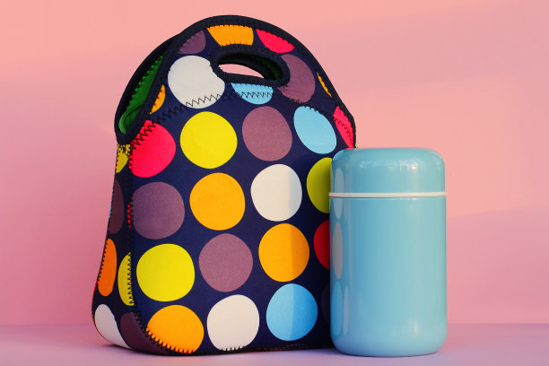 休息时用午餐盒吃点零食。五颜六色的手提包，蓝色的保温瓶。为学生或上班族准备的午餐。放置文本，粉红色背景图片下载