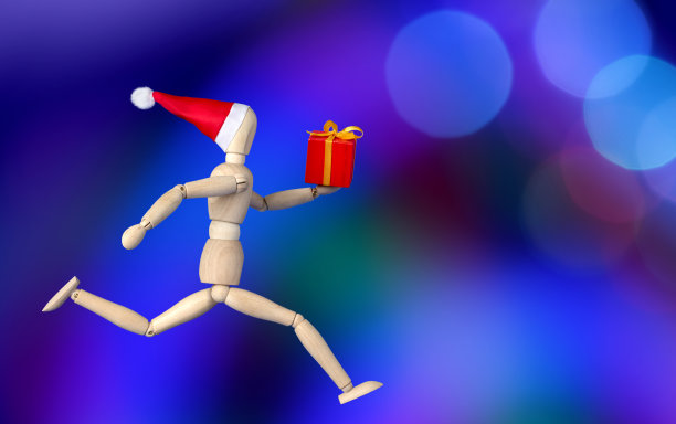 圣诞礼物-运行木制假人在圣诞老人的帽子拿着一个礼盒图片下载