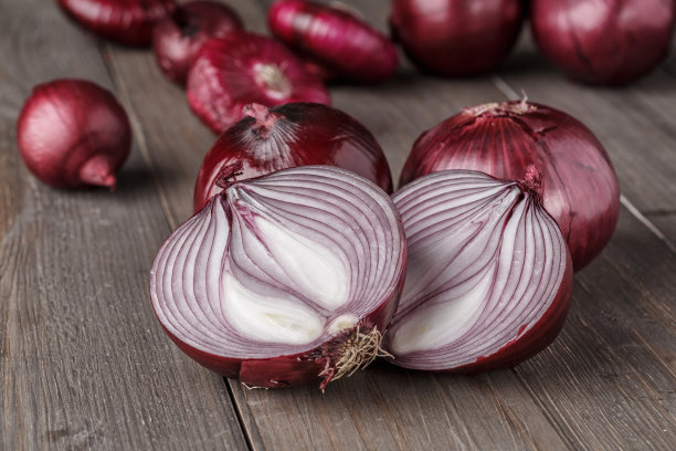 红洋葱在粗糙的木头上图片下载