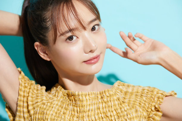 清新美丽的肖像一个年轻的亚洲女人在蓝色的背景图片下载