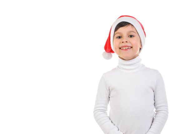 微笑的男孩6岁，圣诞老人的帽子和白色毛衣在白色孤立的背景图片下载