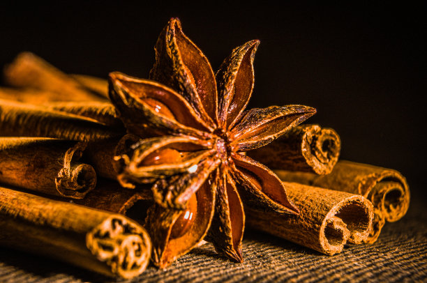 圣诞烘焙香料，肉桂棒和八角星为圣诞蛋糕，饼干或热葡萄酒在黑色背景，微距照片图片下载