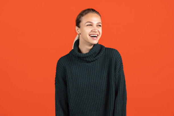 美丽的笑女孩的裁剪肖像孤立的红色背景图片下载